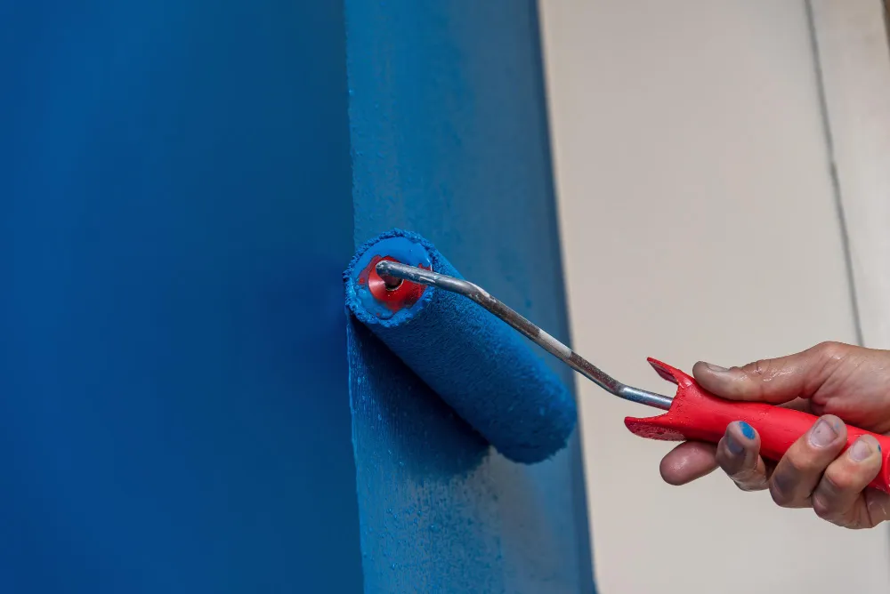 Professional apartment painter maintaining interior walls